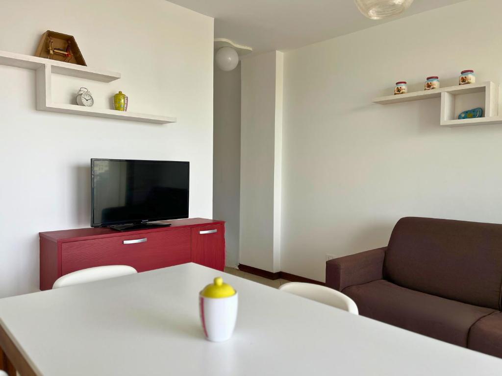 a living room with a table and a couch at City & Sea View T1 with Balcony in Lazareto