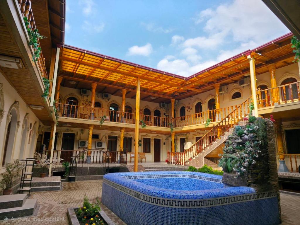 a courtyard with a swimming pool in a building at Al Samarqandi Hotel in Samarkand