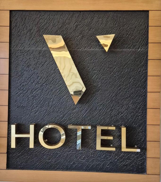 a sign for a hotel with a hiltheastern at HOTEL V in Lucknow