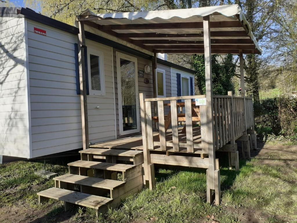 a cabin with a porch and stairs leading to it at Mobil-home Moon River in Thiviers