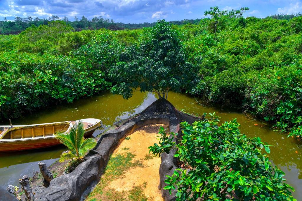 a boat in the middle of a river at Maiya Wild Ship Villa in Kosgoda