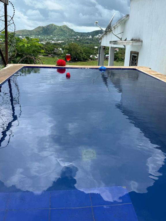 a swimming pool with blue water in front of a house at Villa Bella Vista in Hell-Ville