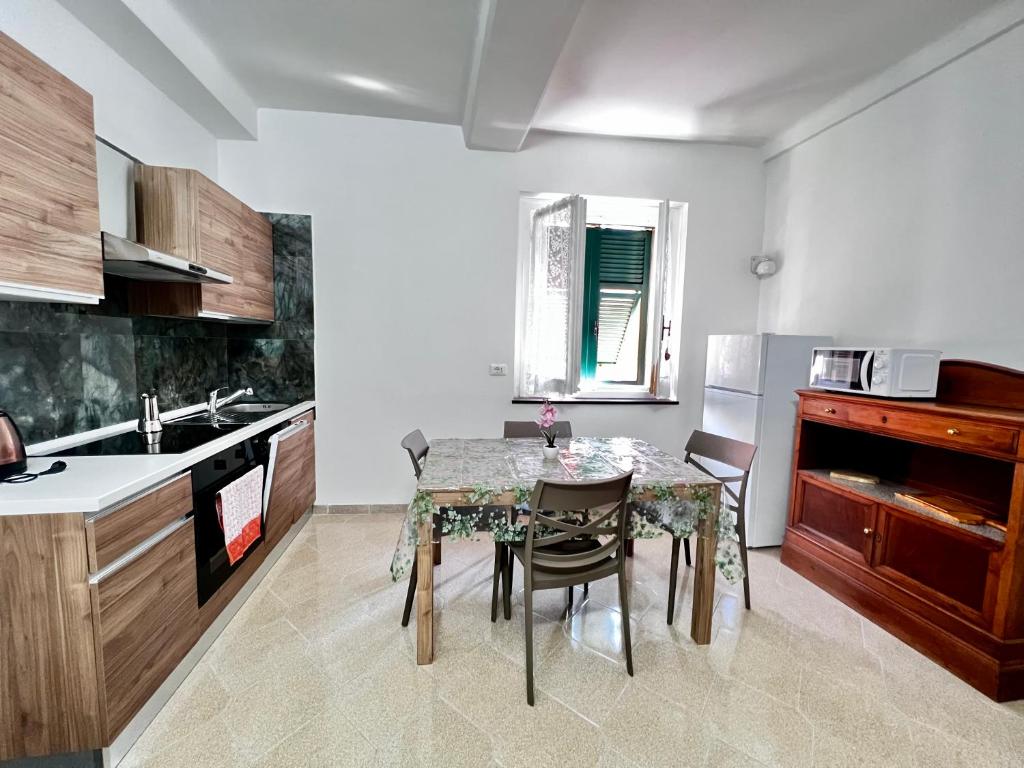 a kitchen with a table and a table and chairs at Kali' in Rapallo