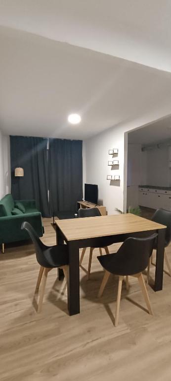 a living room with a wooden table and chairs at Camposa2025 in Muxia