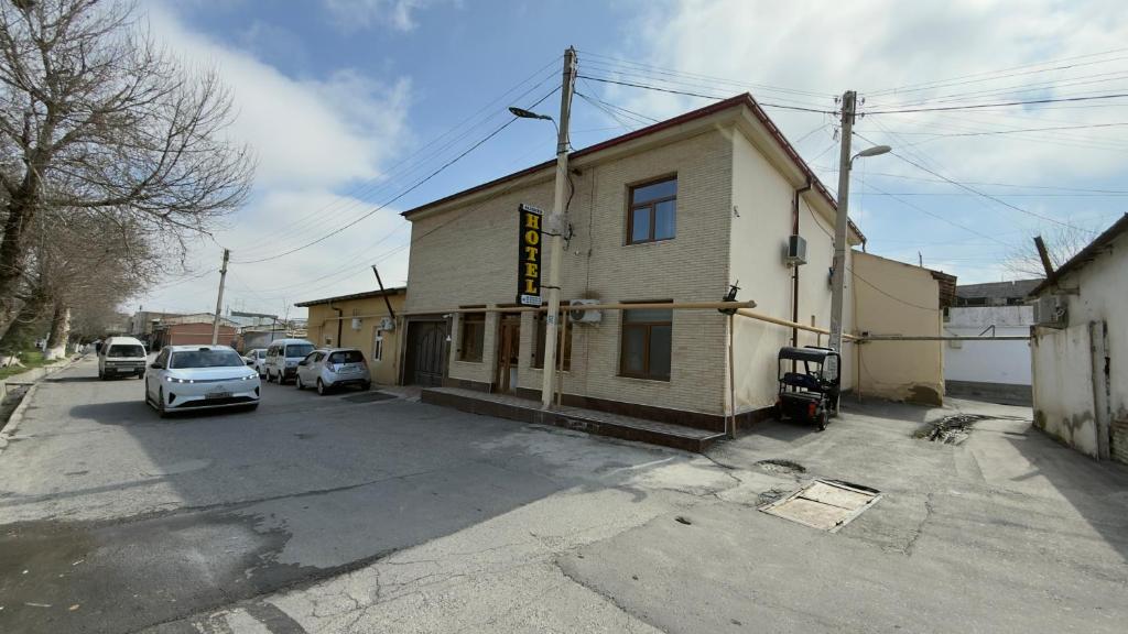 a car parked in a parking lot next to a building at Alisher hotel in Samarkand