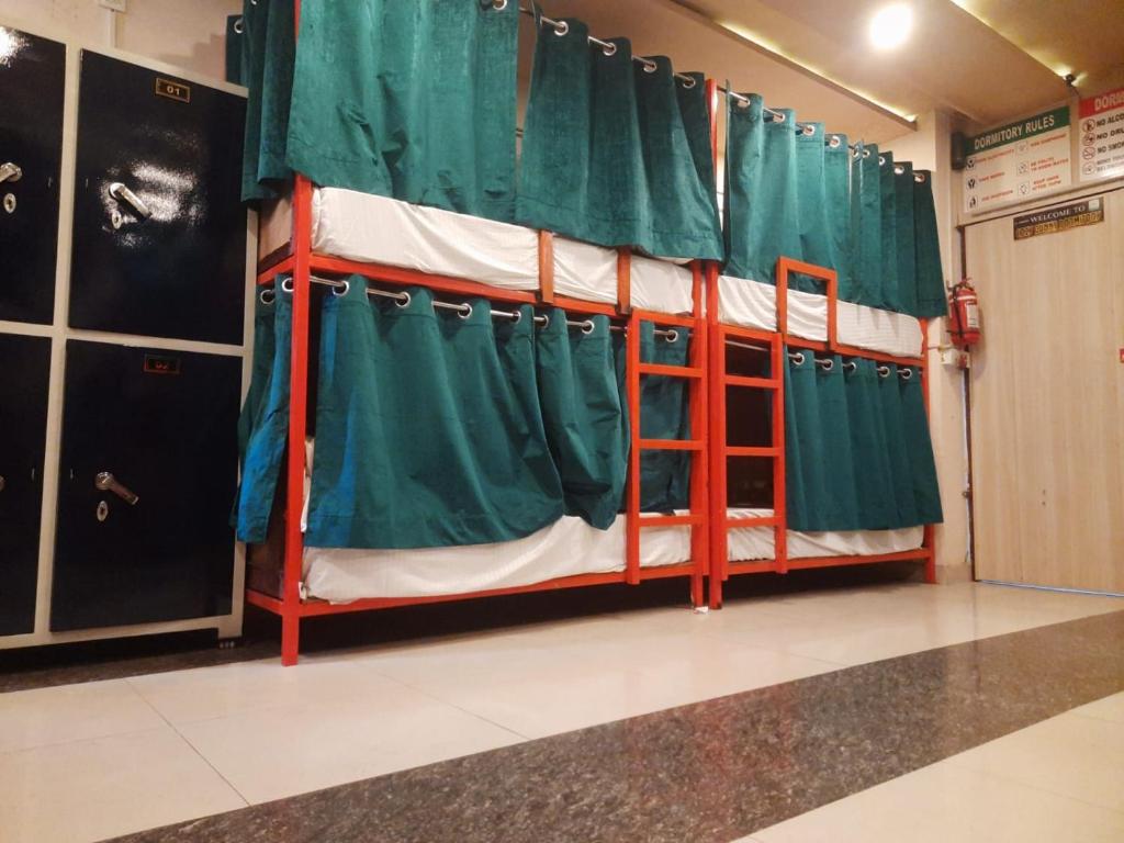 a set of bunk beds in a room with a curtain at Cozy bunks z hostel in Dehradun