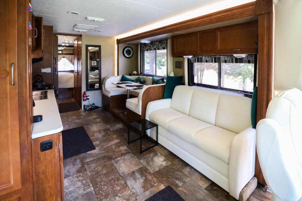 a living room with a couch and a table at Kamper 30m2 max 4 osoby in Ciężkowice