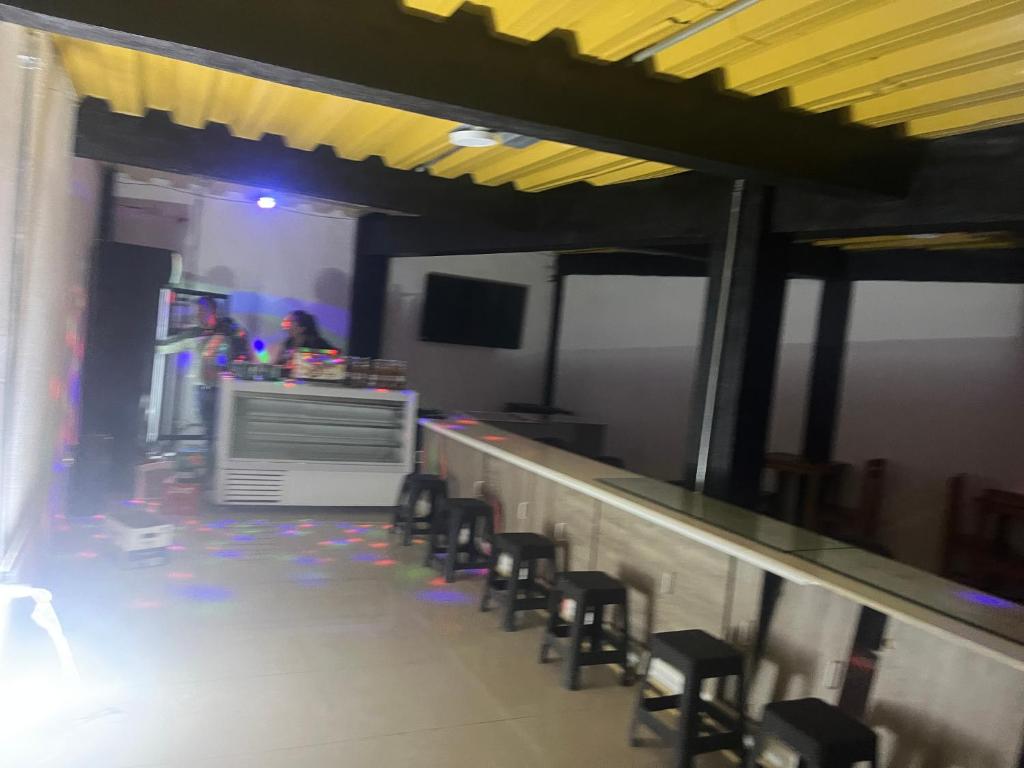 a row of stools at a bar in a restaurant at Duval in Calama