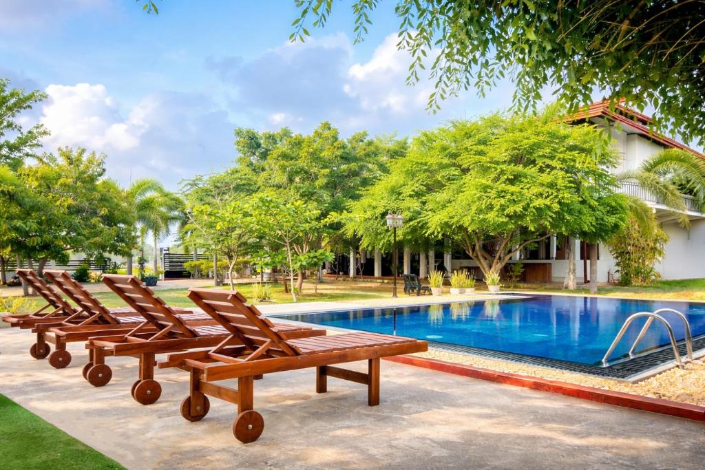 a group of chairs sitting next to a swimming pool at Aqua Hotel Yala in Yala