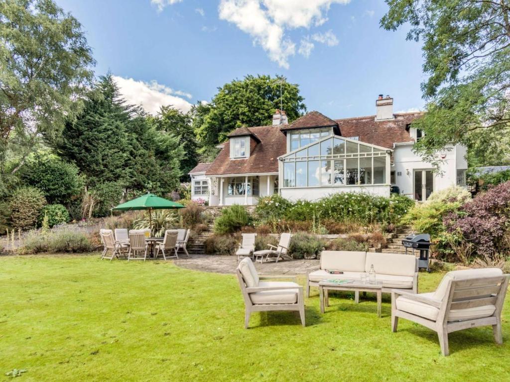 an exterior view of a house with a lawn at 4 Bed in Pulborough oc-89346 in Fittleworth