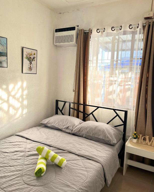 a bed with a toy on it in a bedroom at Casa Ezeah Tagum Staycation in Tagum