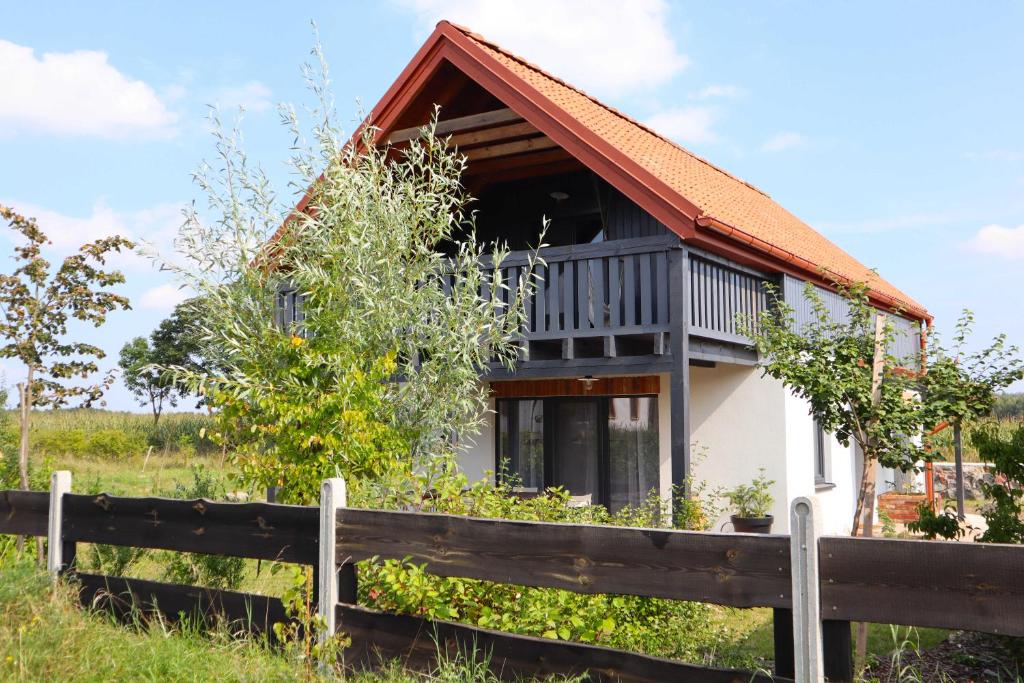 a house with a fence in front of it at Smugi Dom Gościnny in Lipowiec