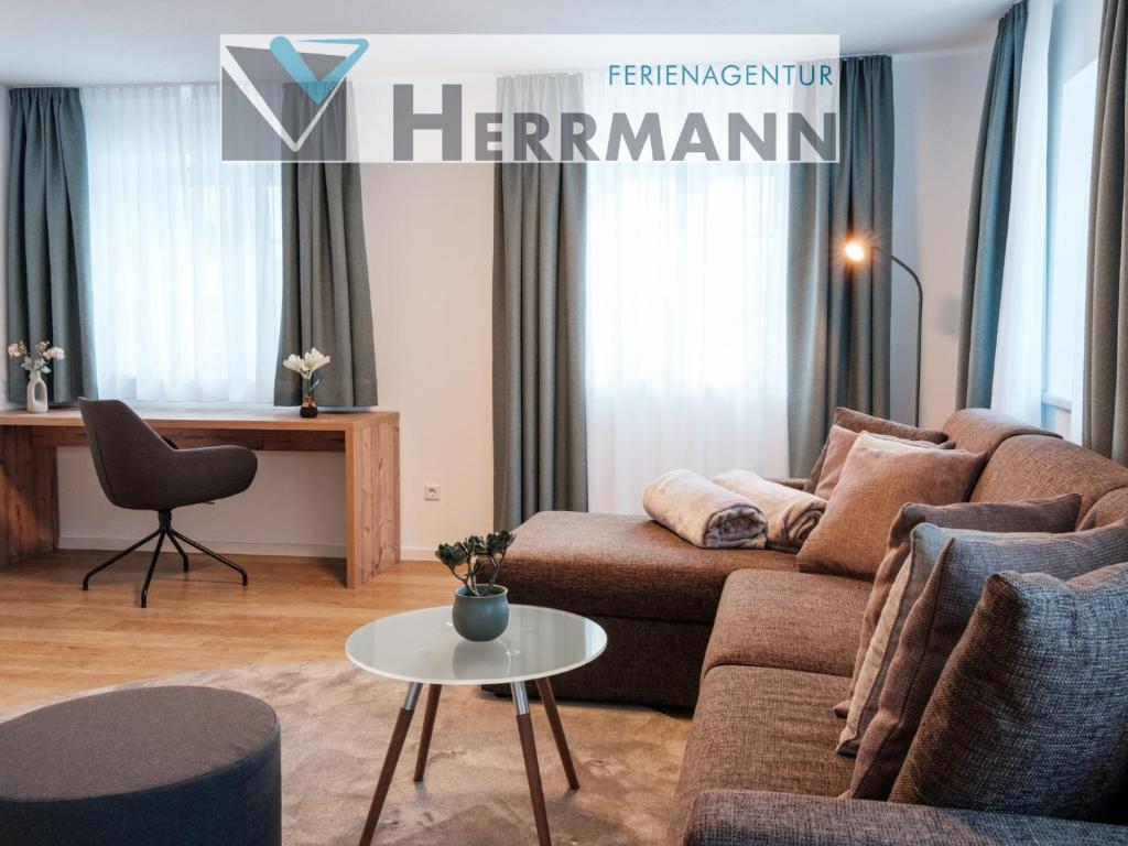 a living room with a couch and a table at Ferienwohnung Beim Paschamarte in Schwangau