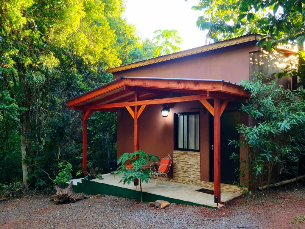 a small house with a pergola on it at Minicasa Rural Maria Preta in Puerto Iguazú