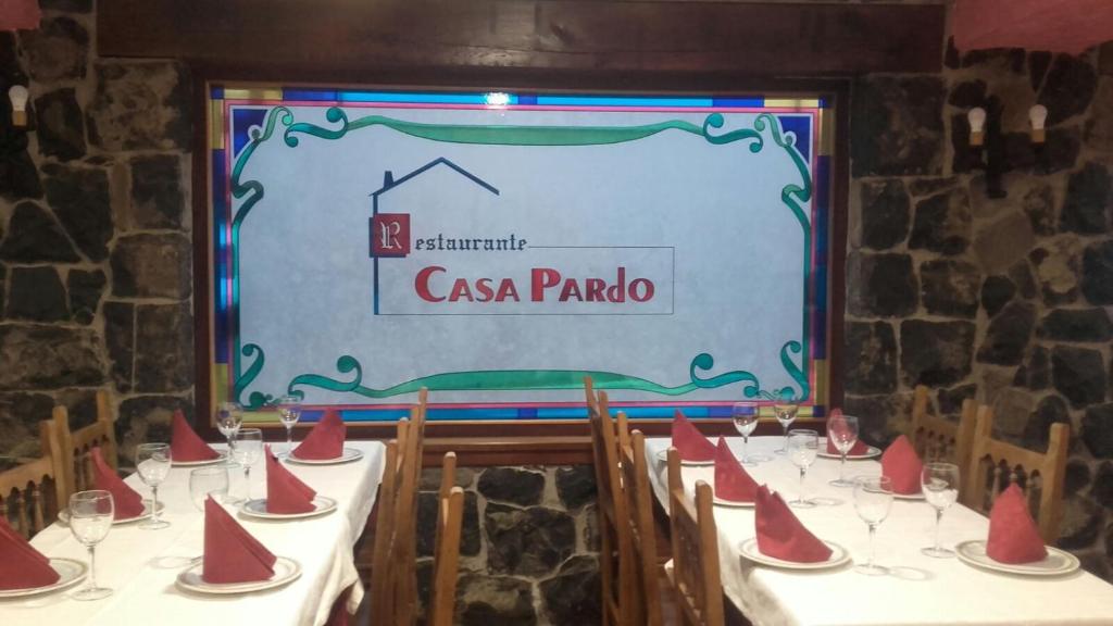 a table with red napkins in front of a sign at Casa Pardo in Gibaja