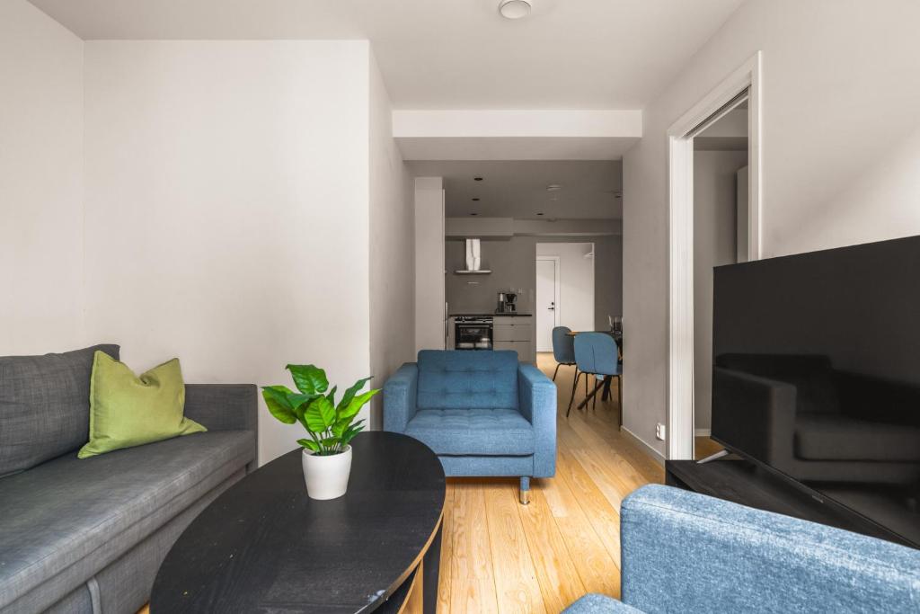 a living room with a couch and a table at Prime Location - 2 Bedroom Apartment! in Bergen