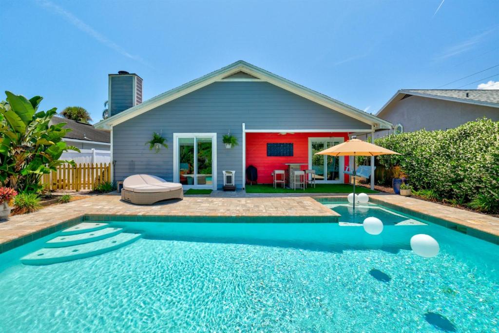a house with a swimming pool in front of a house at PrivateTropical Oasis in Jax Beach in Jacksonville Beach