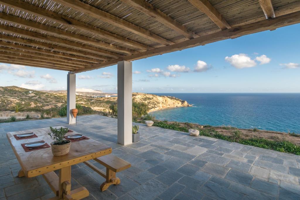 a patio with a table and a view of the ocean at Endless Blue Anesea House in Provatas