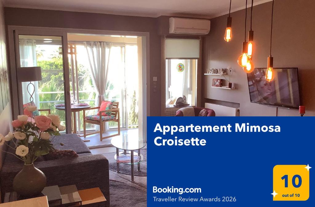 a living room with a couch and a table at Appartement Mimosa Croisette in Cannes
