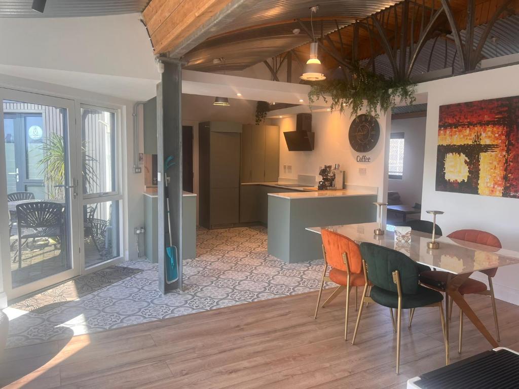 a kitchen and dining room with a table and chairs at Lily's Place in Wexford