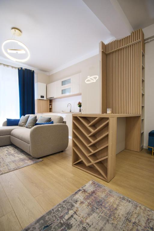 a living room with a couch and a kitchen at ASTI Residence Aparthotel in Năvodari