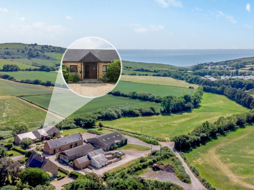 an aerial view of a house in the countryside at 2 Bed in Bridport oc-dc162 in Chideock
