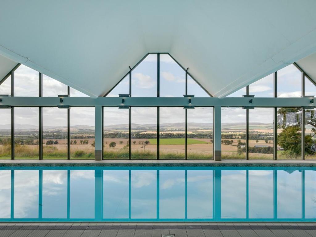 a view of a swimming pool with glass windows at 2 Bed in Forfar oc-92623 in Aberlemno