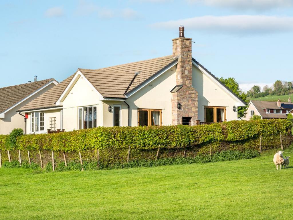 a house with a sheep standing in a field at 3 Bed in Penrith oc-sz299 in Pooley Bridge