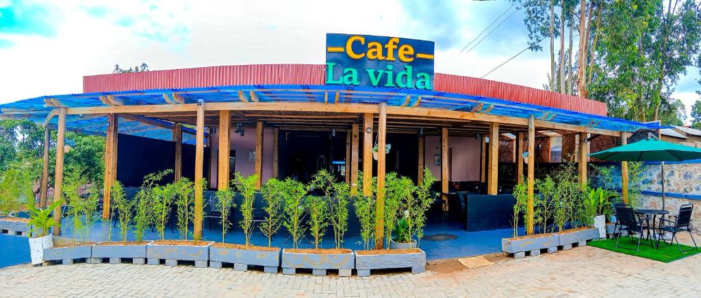 a building with a cafe la vida sign on it at Cafe La Vida in Mbarara