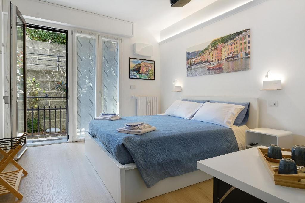 a bedroom with a bed and a desk and a window at Portofino Garden in Rapallo