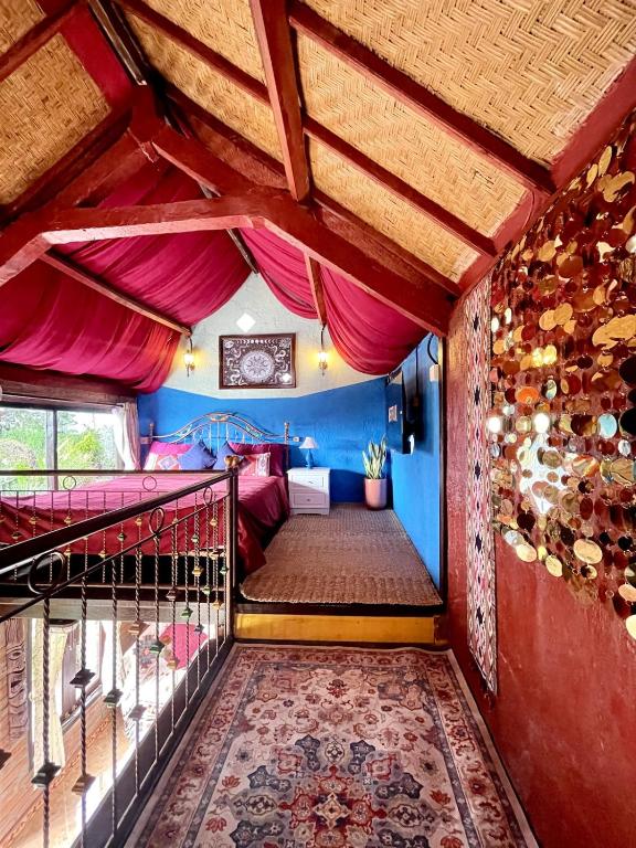 a room with a balcony with a bed in it at Backpackers Cabin with Mountain View in Bedugul
