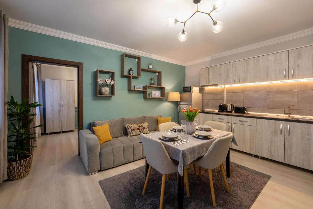 a living room with a table and a couch at Smart Apartments Central in Sighişoara