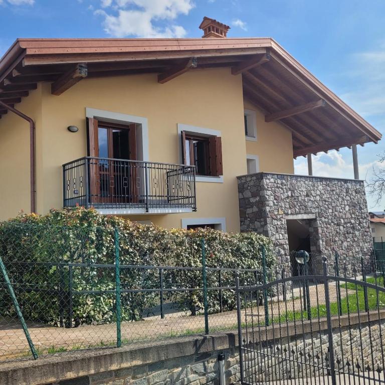 a house with a fence in front of it at Casa Gioia Alpina Mountain Lake Iseo Hospitality in Bossico