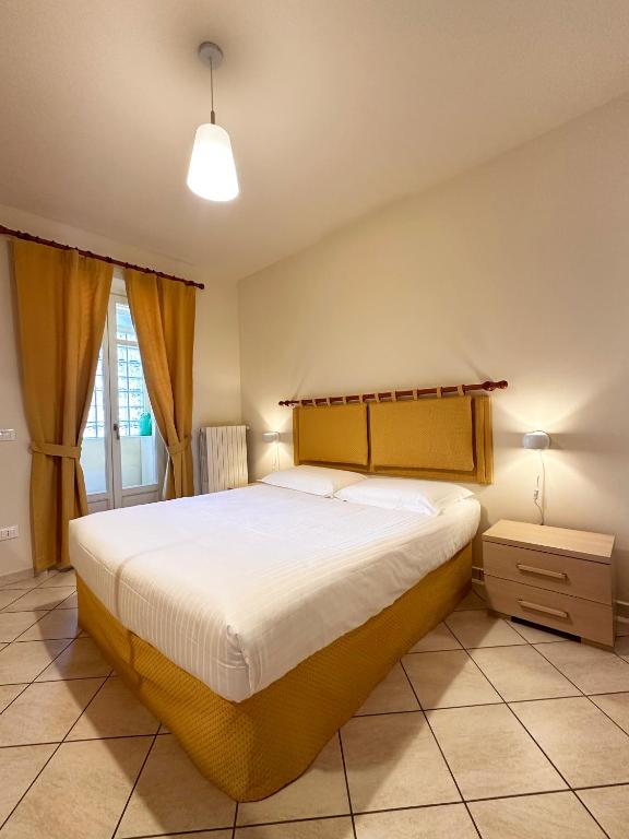 a bedroom with a large bed in a room at Made in Langhe Apartment in La Morra