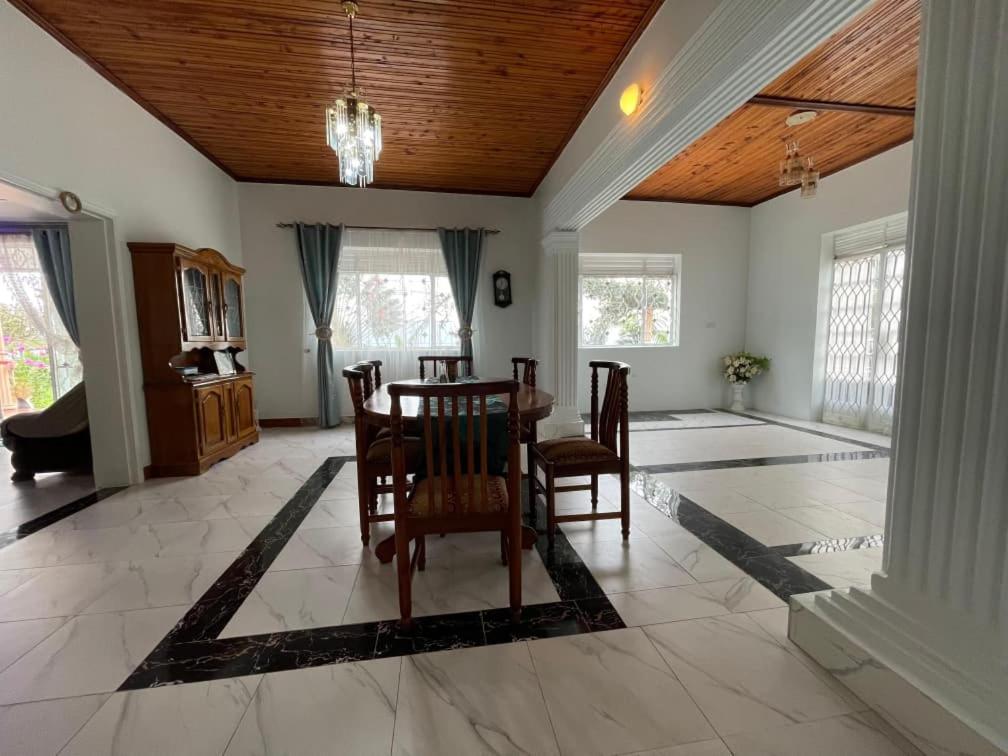 a dining room with a table and chairs at Angel's place in Kabale