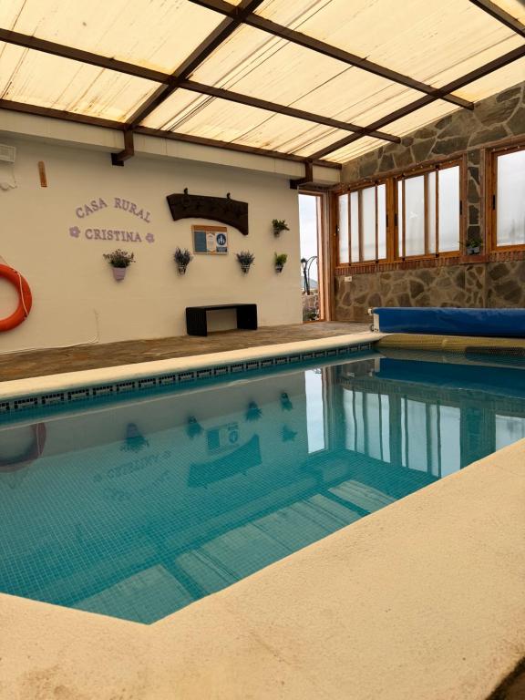 a swimming pool in a house with a large pool at Casa rural Cristina- Piscina climatizada in Málaga