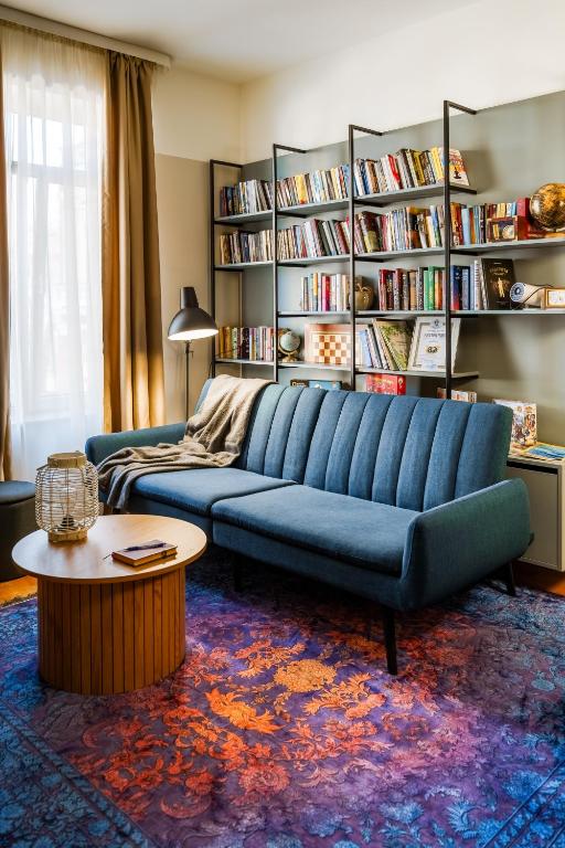 a living room with a blue couch and a table at The Nest in Ruse