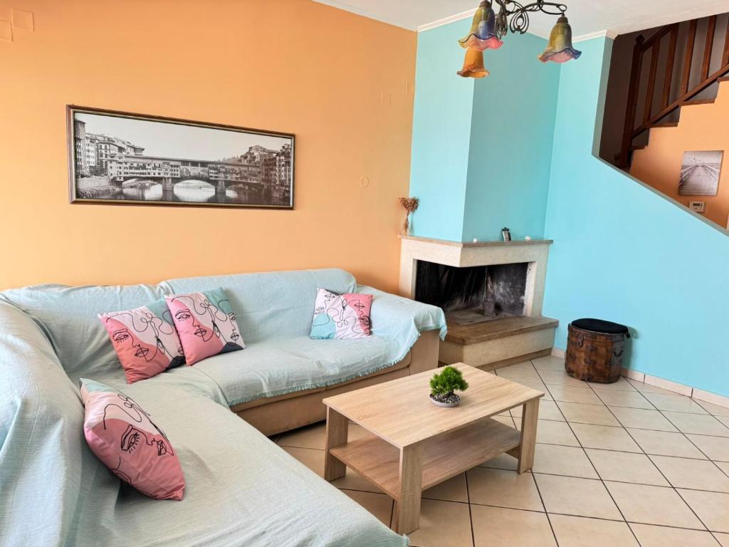 a living room with a couch and a fireplace at The Sea View kanali in Kanali