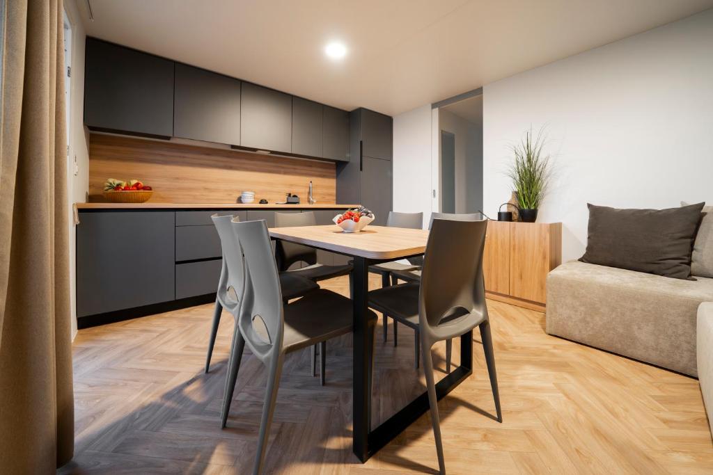 a kitchen and dining room with a table and chairs at Punta Falconera camping & village in Caorle