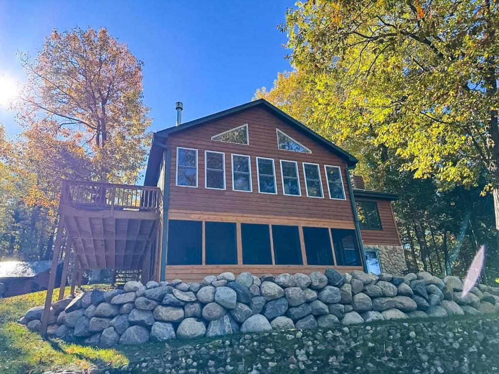 a house with a bunch of rocks in front of it at Hilltop - Bouchard Shores Resort in Minocqua