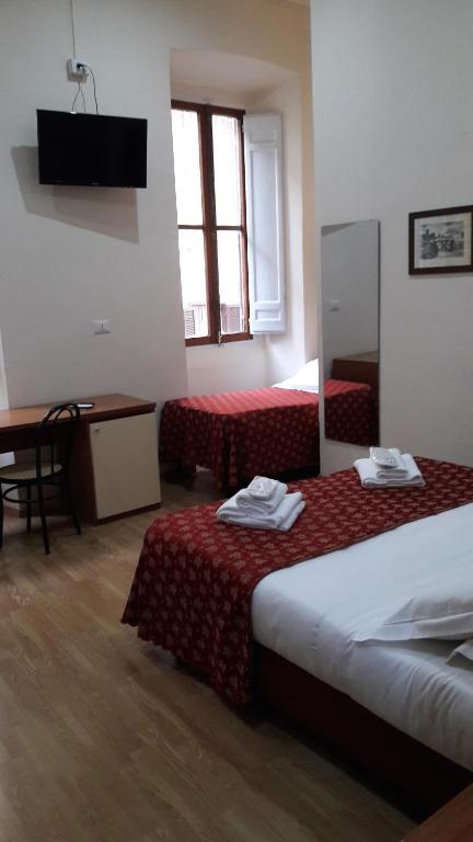 Postel nebo postele na pokoji v ubytování Hotel Mimosa Pantheon