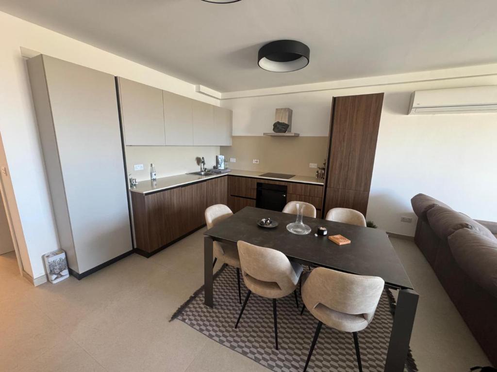 a living room with a table and chairs and a couch at Ta' Cenc Residence Block C, Apt 4 in Sannat