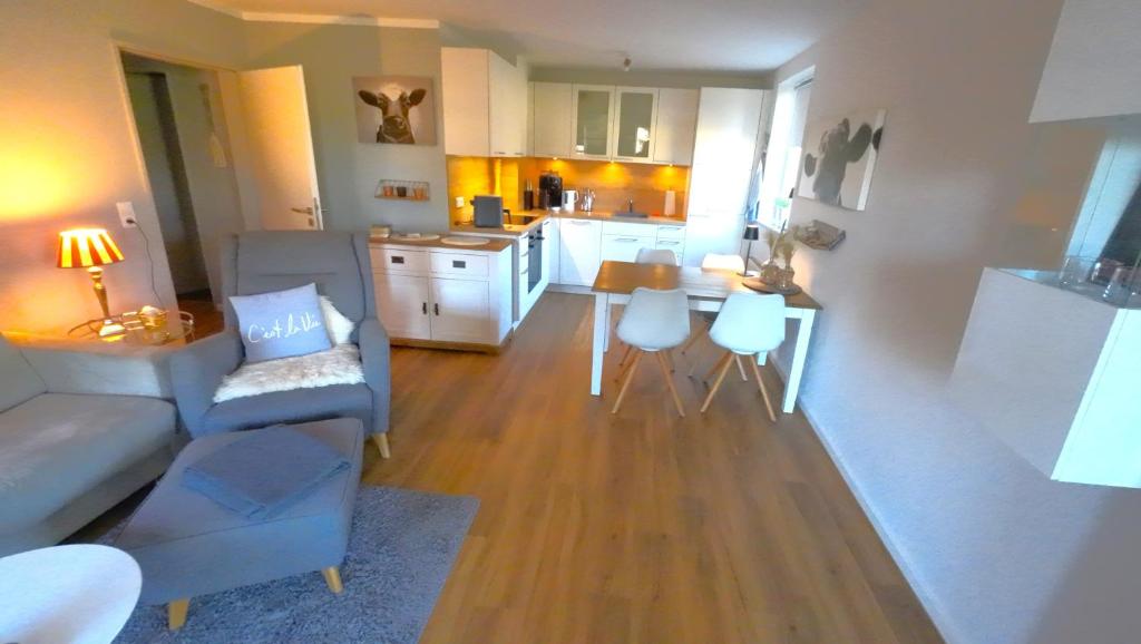 a living room and kitchen with a couch and a table at Beachhouse in Eckernförde