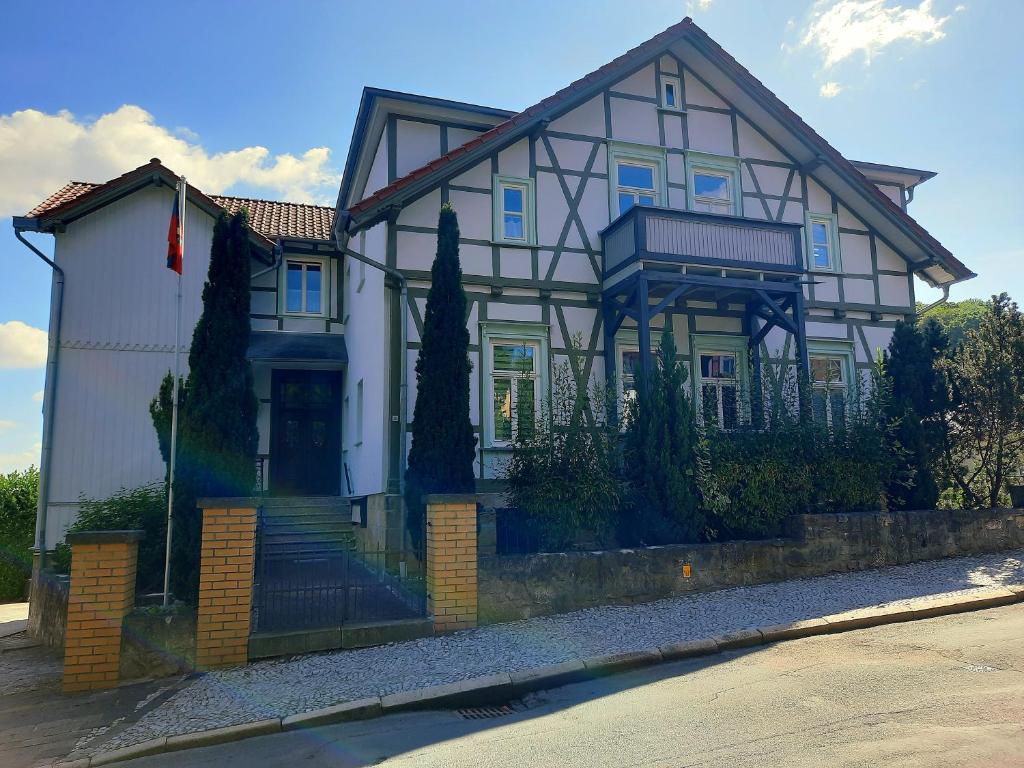 a large white house with a black at Ferienwohnung Berthold WG 6 in Blankenburg