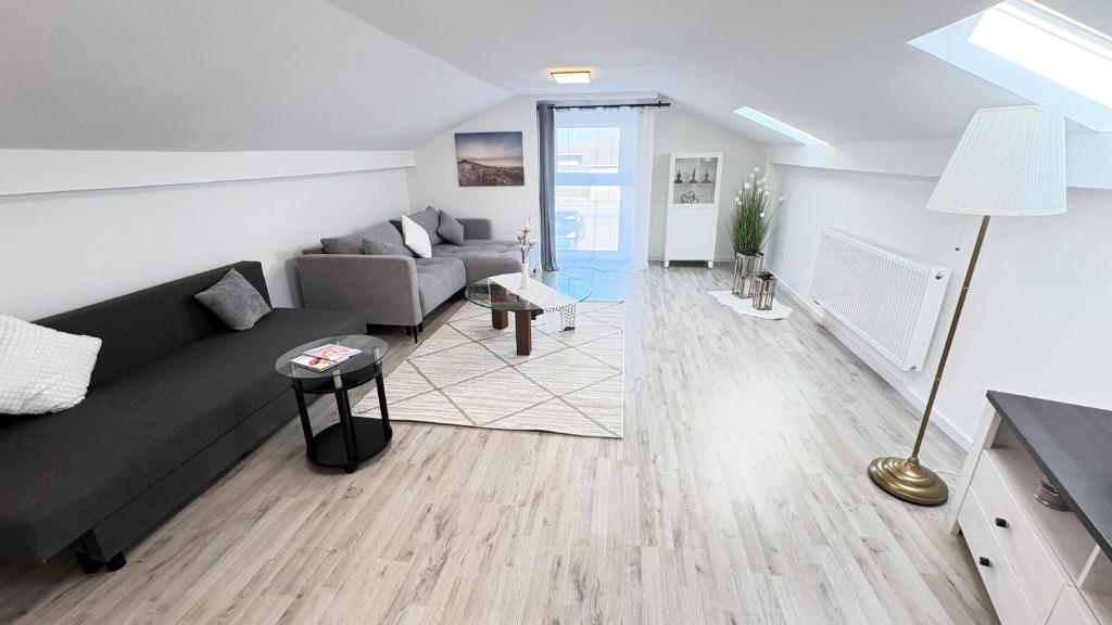 a living room with a couch and a table at Ferienwohnung Melody in Weisweil