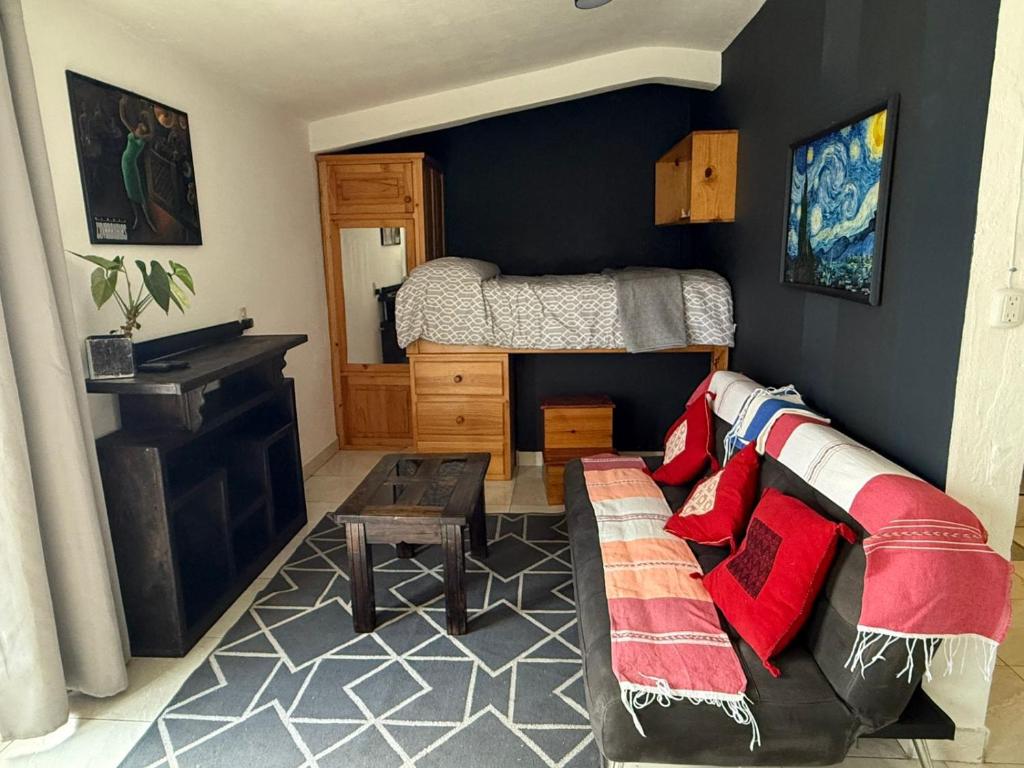 a living room with a couch and a bed at Loft zona centro La Merced in San Cristóbal de Las Casas