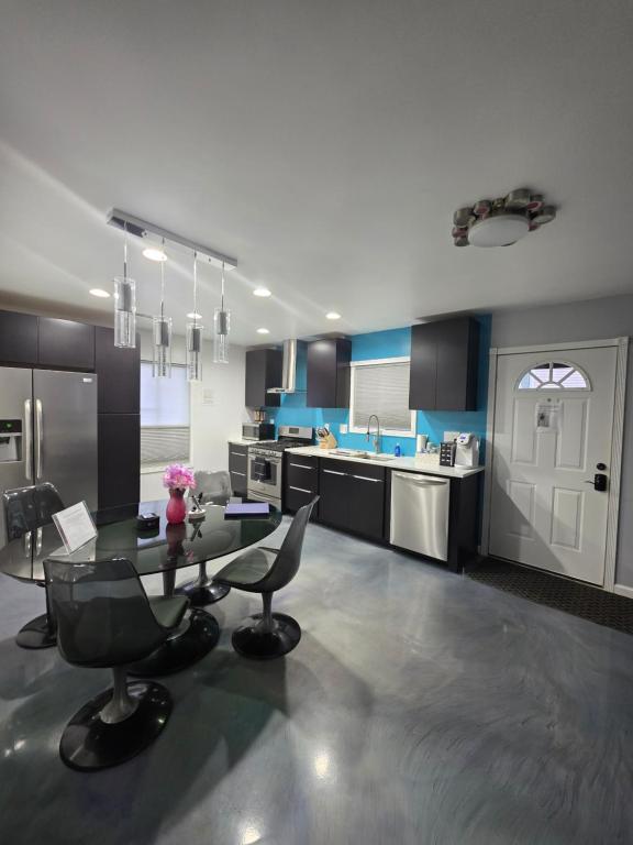 a large kitchen with a glass table and chairs at Modern Retro 2BR Condo in High Point