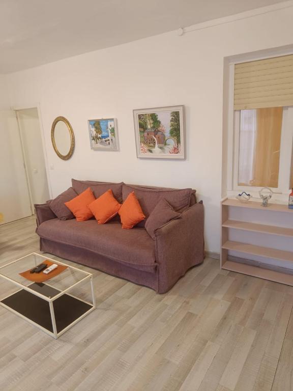 a living room with a brown couch and a table at Mediterraneo in Vinarós