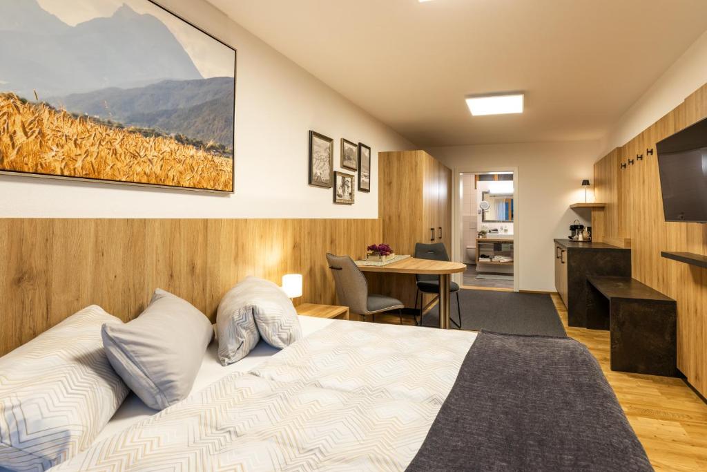 a hotel room with a bed and a table at Studio Toblaten in Inzing