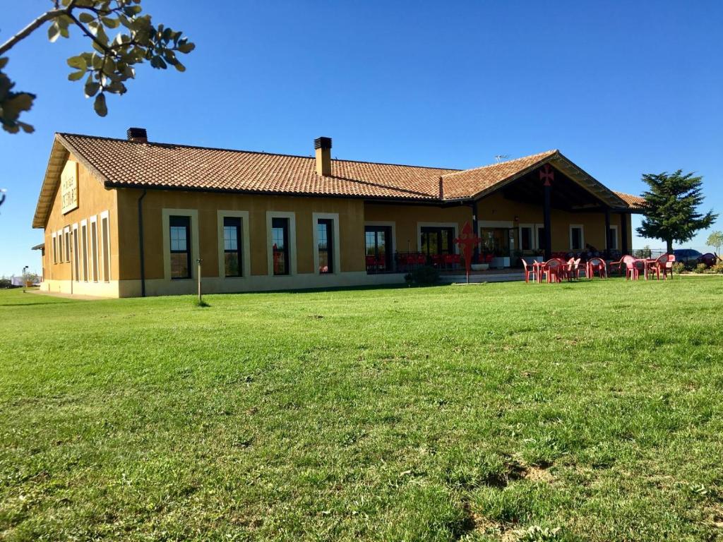 a large building with a lawn in front of it at Albergue Los Templarios in Terradillos de Templarios